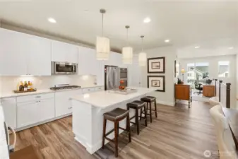 View of the kitchen leading to living room with upper deck.