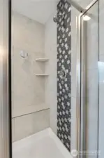 Primary shower with beautiful tile work.