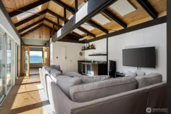 Huge family room with vaulted ceilings, ideal for viewing ball games, evening movies, equipped with newer wet bar, storage, wine fridge. Tons of natural light throughout this home.