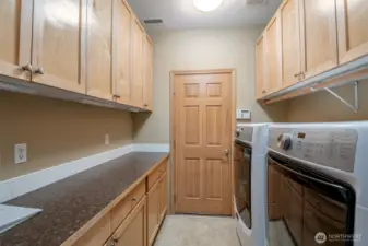 The laundry is convieniently located off the main hall and leads to the garage. More custom built-ins for more storage and the washer and dryer convey!