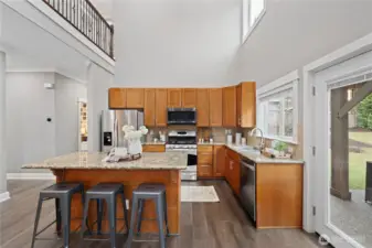 Another view of the kitchen, sink with large window, and French doors to the back yard.