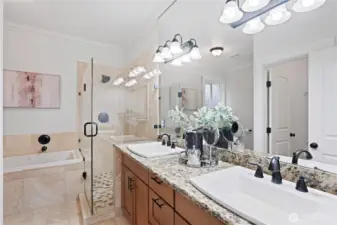 Primary suite bath with heated floors, double vanities, walk-in shower, separate jetted tub and commode with heated seats.