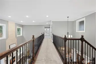 This dramatic catwalk leads to the privte office and generous bonus room.  Great views from here to the great room, dining room, and the front entry.