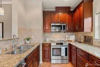 Solid wood cabinetry, slab counters and stainless appliances. Even cooking with a view.