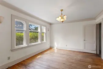 Spacious dining room with original crown molding, oak floors and picture windows which have been updated.