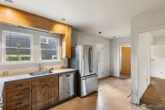 The kitchen has space to put a small table for informal dining and a door letting out to a large deck for BBQing or entertaining.