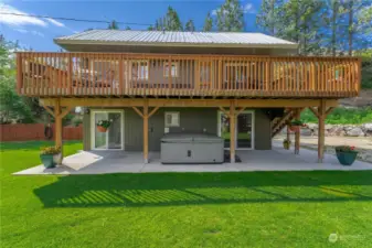 Exterior view of Upper Level lake view deck, private spa & grassy lawn & landscaped yard.