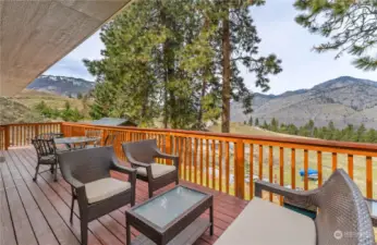 Upper Level lake view deck w/ sitting area & outdoor dining & BBQ space.