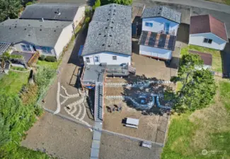 Main home on left, shed and garage with studio space on the right.