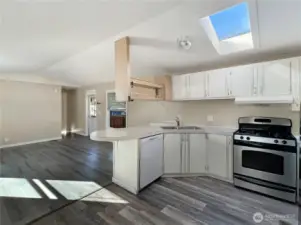 Kitchen also offers a gas stove and skylight.