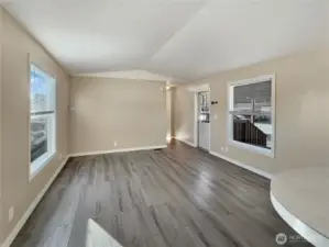 Family room features vaulted ceilings and laminate flooring throughout.