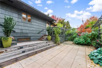 Yard features bluestone and peach granite hardscape