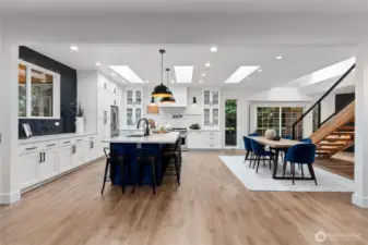 Gormet Chefs kitchen with expansive island with gorgeous waterfall quartz countertop!