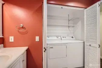 The bathroom includes an ensuite laundry closet, complete with a brand new, top-of-the-line A.O. Smith electric hot water heater located on the left.