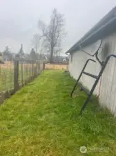 Fence line behind garage