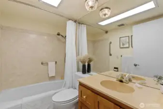 Full size hall bath with refreshed vanity and ceramic tile flooring.