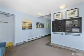 Secure lobby with mailboxes and a great community board with information around the corner.