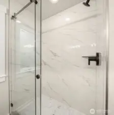 Luxurious marble-accented shower.