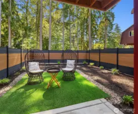 Fully private backyard with easy-care synthetic turf.