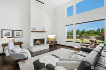 Magnificent 2 story living room with soaring cathedral ceilings & dramatic limestone fireplace