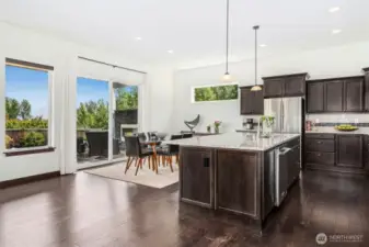Elegant dining area that flows out onto the expansive covered composite deck with outdoor fireplace & patio