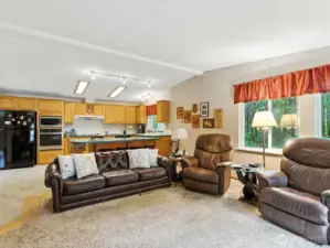 The bright and casual living space seamlessly merges the kitchen and family room, creating a welcoming and connected atmosphere.