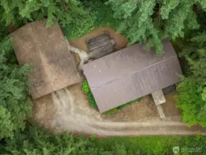 This photo offers a great overview of the main property, showcasing the home and the detached garage/shop in one expansive view.