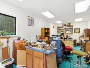 Attached to the garage of the main home is a versatile office space that offers incredible potential. While it may currently appear a bit cluttered, take a moment to look past the mess and focus on the possibilities.