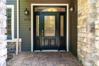 Welcoming covered entrance to greet your guests, with stamped concrete steps and landing