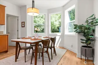 Sunny eating nook off kitchen with bay window offers pleasant backyard views