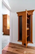 Secret storage closet hidden behind revolving bookcase