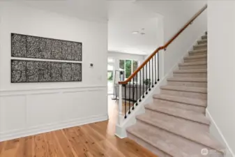 Wide staircase with lower open spindles, guide you to the upper floor