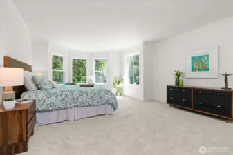Considerable primary suite with quaint sitting area can easily accommodate a king size bed, and dresser
