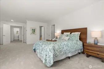 Well-appointed primary suite with double door entry, full bath, and walk-in closet