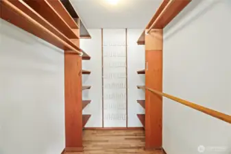 LARGE WALK IN CLOSET with built in shelves, shoe rack & bifold door entry