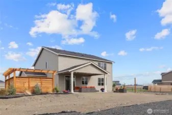 Backyard, with additional patio space, thoughtfully designed privacy arbor, and covered patio.
