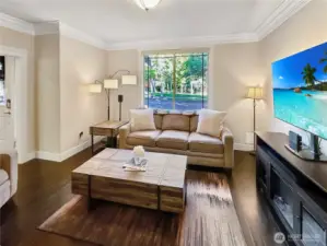 Family room features hardwood floors and crown molding.