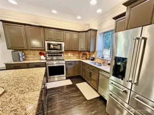 Kitchen with newer upper end appliances that will stay with the home.  Granite countertops and plenty of storage.  Smart lighting throughout the home.