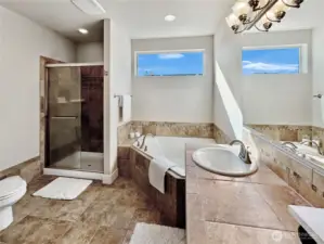 Primary bath offers soaking tub and separate shower.