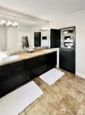 View of double vanities in primary, covenient storage/medicine cabinet.