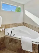Corner tub in primary is perfect for a relaxing soak.