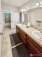 Upper hall bath offers double vanities.