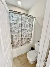 Separate shower and toilet room in upper hall bath can be closed off from vanities.