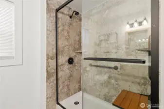 Ensuite bath in primary has flip down cedar seat for steaming and relaxation