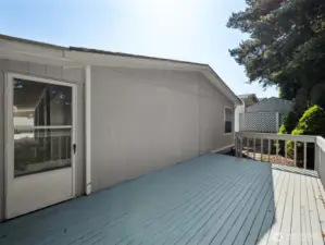 Out the back of the carport, you will find this HUGE, PRIVATE deck! Trees all around, very quiet and peaceful.