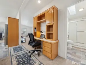 As you enter from the carport, you pass through the utility room into the main hallway. A really nice space for an office, kitchen and dining to your hard left, living room straight ahead and kids/guest 3/4 bath to your right.