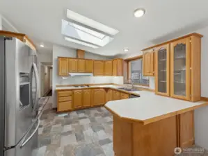 Kitchen view from dining room. I love the skylight, all the counter and cupboard space, and the included stainless steel appliances. Just add bar stools and you have a nice breakfast bar!