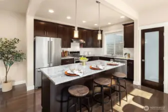 Nicely appointed kitchen features slab granite counters, stainless appliance package, subway tile backsplash and pantry storage