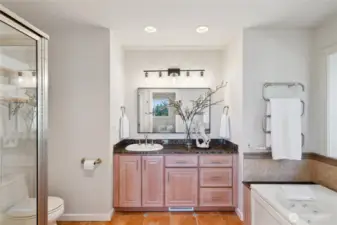 Primary bathroom, jetted tub, heated towel rack, and under floor heating.  There's a Bay window above the tub with Courtyard and fountain views.
