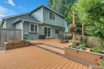 Large two tiered deck in back yard with built-in custom lighting